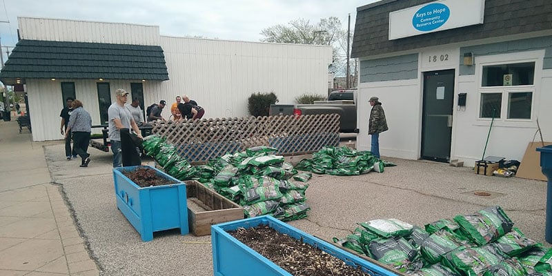 Volunteers improve community garden spaces outside the Keys to Hope Community Resource Center.