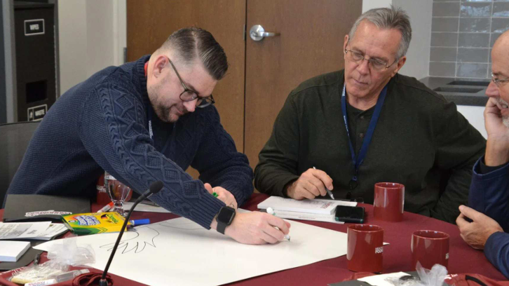 Community leaders collaborate during a planning and strategy meeting focused on housing, support services, and community programs.