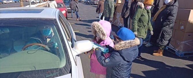 Children volunteer during a community food distribution event serving families throughout La Porte County.