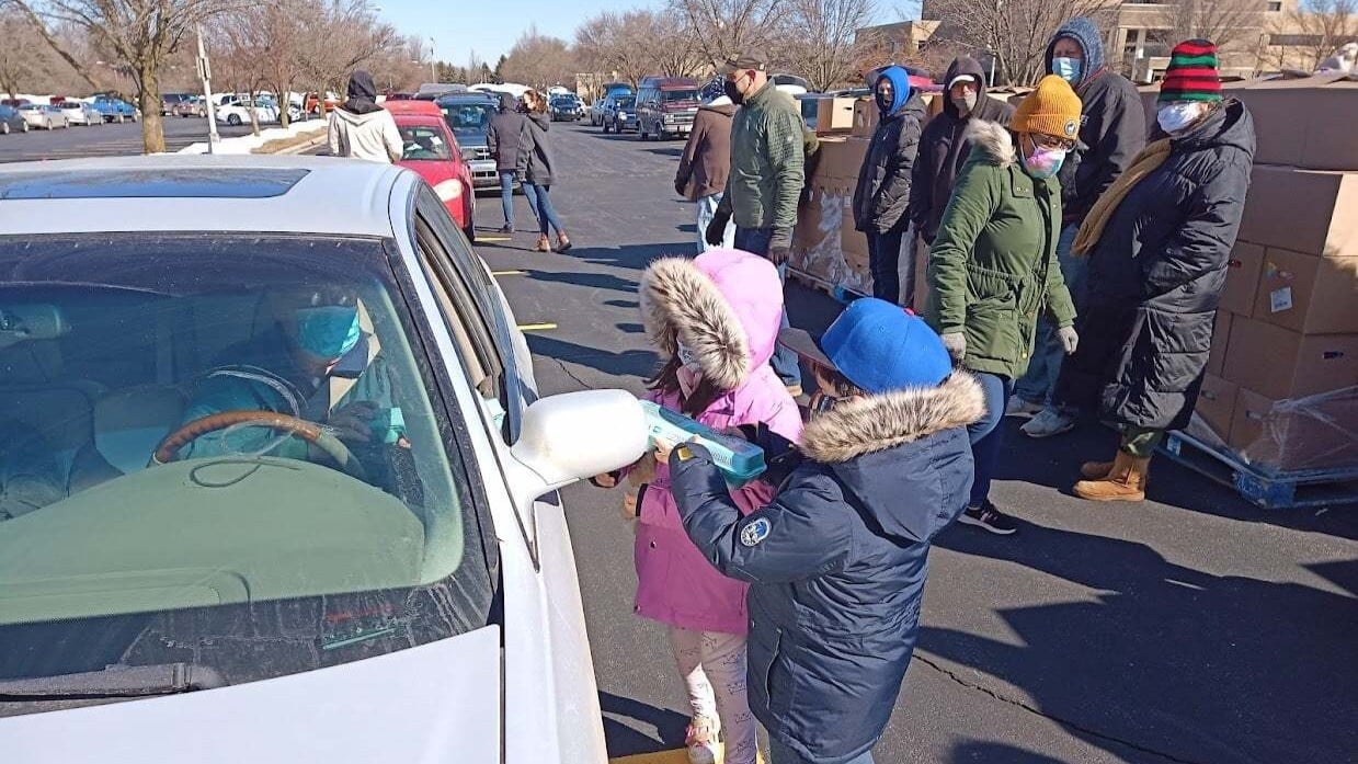 Children volunteer during a community food distribution event serving families throughout La Porte County.
