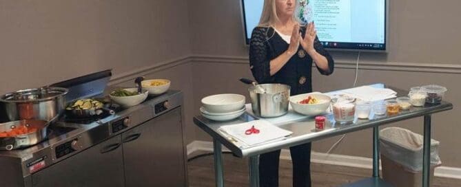 Instructor leads a healthy cooking class at Grace Learning Center, teaching practical nutrition and meal preparation skills.