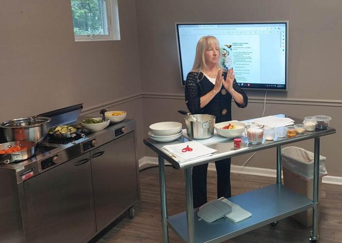Instructor leads a healthy cooking class at Grace Learning Center, teaching practical nutrition and meal preparation skills.