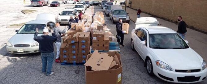 Volunteers organize and distribute food to local families through a large-scale community food assistance program.