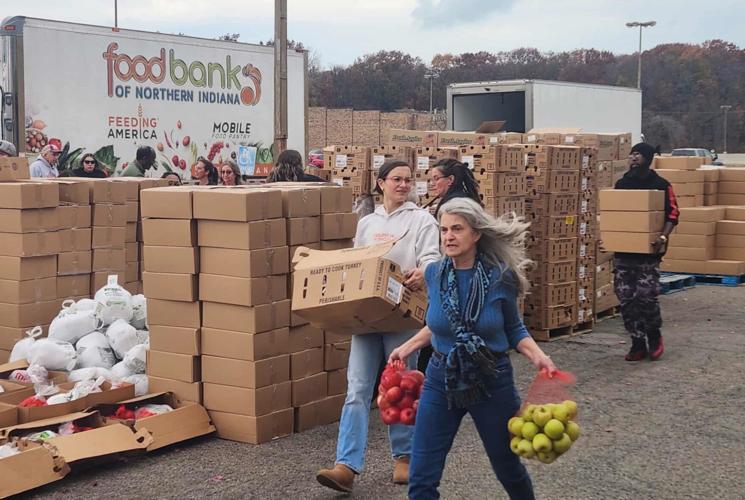 Volunteers sort and distribute fresh produce and groceries during a Food Bank of Northern Indiana mobile food distribution event.